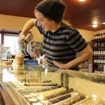 Kyle Jensen / The Record &mdash; Sweet Mona&rsquo;s employee Gin Woodside tops off a customers beverage with whipped cream. Owner Mona Newbauer is expecting February to be one of her busiest months.