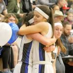Evan Thompson / The Record &mdash; South Whidbey seniors Bailey Forsyth (left) and Megan Drake (right) hug after exiting Friday night&rsquo;s game against King&rsquo;s on senior night. The Falcons lost 60-40.
