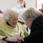 Kyle Jensen / The Record &mdash; Wells gives a final embrace with a friend after her discussion at Unitarian Universalist Congregation Tuesday afternoon.