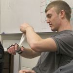Evan Thompson / The Record &mdash; South Whidbey senior Hunter Newman rolls a protective wrap around his right hand before practice on Thursday afternoon. Newman broke his hand two weeks ago.