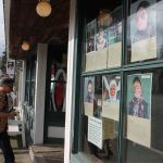 Record file &mdash; Pictures of the characters from last year&rsquo;s Mystery Weekend are posted outside a Langley storefront.