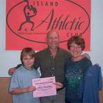Record file &mdash; Spratt, 9, accepts a donation of $345 from Steve Shapiro and Debora Valis of Island Athletic Club for the 2010 Good Cheer Talent Show raffle.