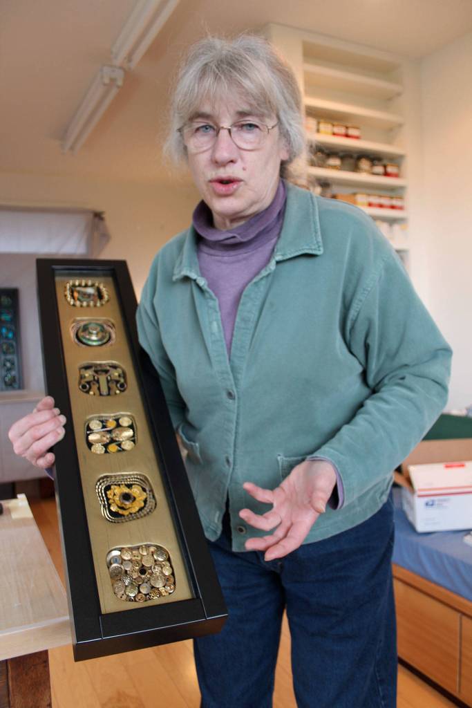 Kyle Jensen / The Record &mdash; Freeland carpenter and artist Janet Pheifer holds one of the pieces that will be featured at the exhibit. The piece is made from collected junk she meticulously organizes in her studio.