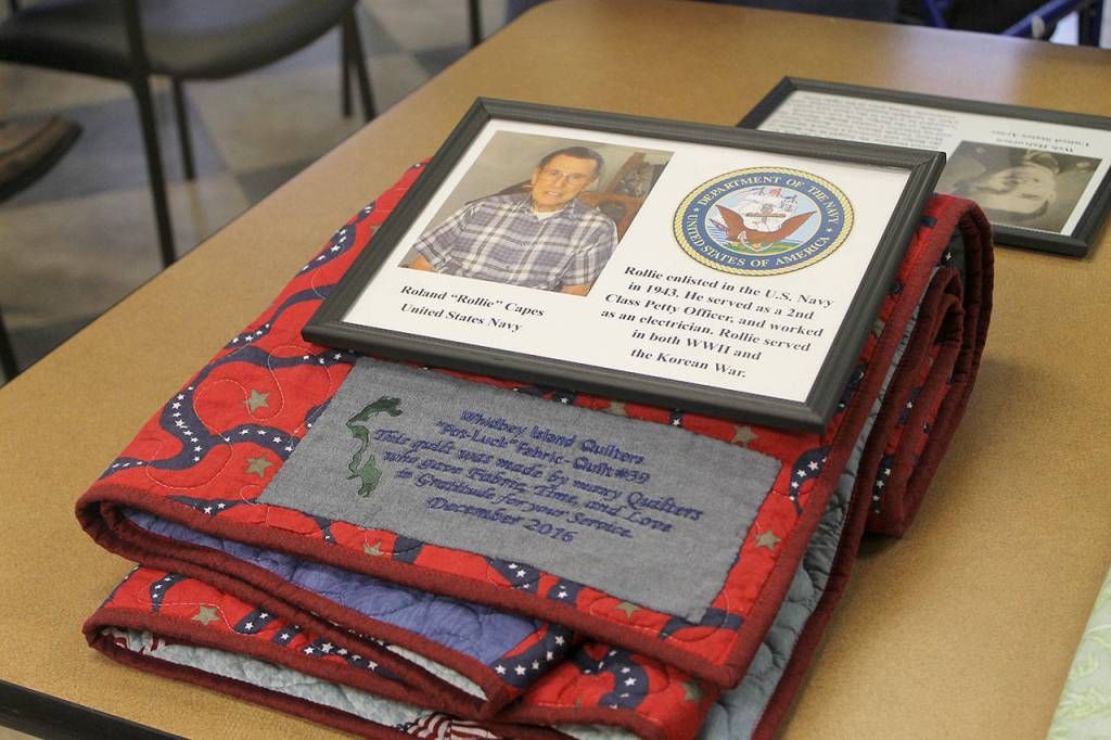 Evan Thompson / The Record                                 Twenty World War II veterans and veterans of other wars were honored on Thursday at Maple Ridge Retirement and Assisted Living Community&rsquo;s activity room. Shown in this picture is Roland &ldquo;Rollie&rdquo; Capes&rsquo;s quilt.