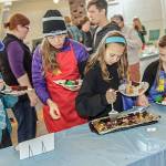Contributed photo &mdash; Participants from the 2016 South Whidbey Edible Book Festival wait their turn to sample one of the entries.