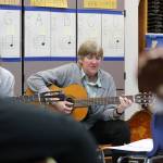 Evan Thompson / The Record &mdash; South Whidbey Elementary School teacher Jean Cravy strums the guitar during a practice session on March 7 inside South Whidbey Elementary School&rsquo;s music room.