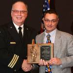 Photo courtesy of Stadler Studio &mdash; Tom Gideon receives the firefighter of the year award from Deputy Chief Mike Cotton.