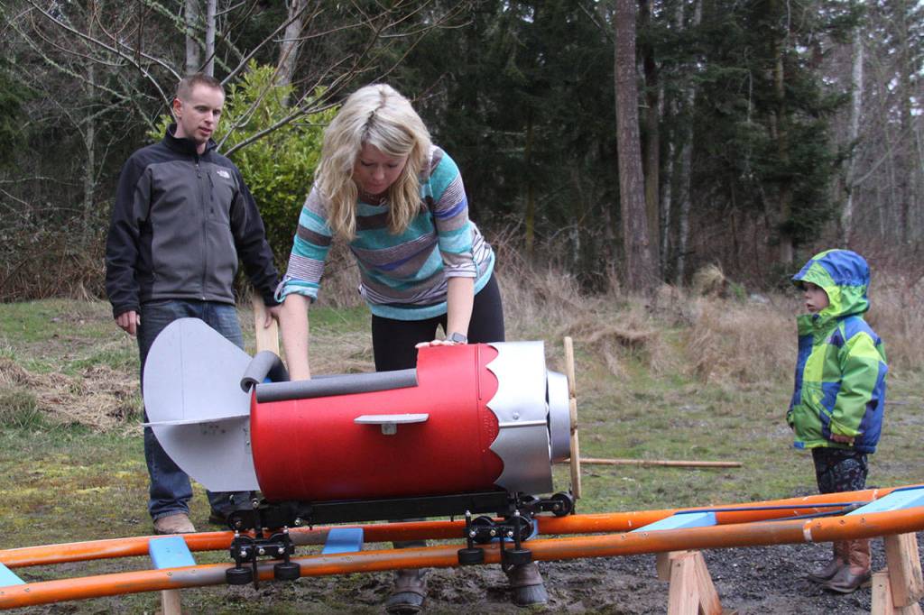 Brittany Brazelton does a safety check before her son Wyatt goes on a ride around the roller coaster track Wednesday, March 1, 2017. Photo by Ron Newberry/Whidbey News-Times