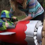 Wyatt Brazelton gives a thumbs-up while his mother Brittany straps him in before take-off of his roller coaster cart Wednesday, March 1, 2017. Photo by Ron Newberry/Whidbey News-Times