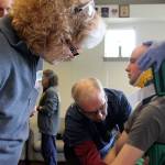 Kyle Jensen / The Record &mdash; EMT trainees strap &ldquo;patient&rdquo; Sean McDougald to the Kendrick Extrication Device. The device is used to remove patients from vehicles in non-urgent situations.