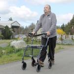 Evan Thompson / The Record &mdash; Art Durand, a Coupeville resident and Navy veteran, walks down the street with a Dolomite walker provided to him by the Veteran&rsquo;s Administration.