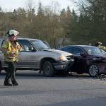 Kyle Jensen / The Record &mdash; South Whidbey Fire/EMS Deputy Chief Mike Cotton surveys the scene of a collision at the intersection of Highway 525 and Harbor Avenue in Freeland.