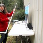 Island County environmental health educator Maribeth Crandell demonstrates a sludge stick used to measure accumulation in a septic tank. Photo by Patricia Guthrie/Whidbey News-Times