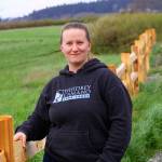 Jessica Larson, a land steward with the Whidbey Camano Land Trust, stands before a split-rail fence Thursday, Aprl 6, 2018 that was installed in March to keep duck hunters and others from parking on the property near Crockett Lake in Central Whidbey. The land trust purchased the 85-acre property from a private landowner in December on the lake&rsquo;s northeast corner to protect it and its abundant species of birds as part of the 423-acre Crockett Lake Wetland Preserve. The newly acquired property had been a widely used access point and place to park for waterfowl hunters for years. Photo by Ron Newberry/Whidbey News-Times