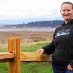 Jessica Larson, a land steward with the Whidbey Camano Land Trust, stands before a split-rail fence Thursday, Aprl 6, 2018 that was installed in March to keep duck hunters and others from parking on the property near Crockett Lake in Central Whidbey. The land trust purchased the 85-acre property from a private landowner in December on the lake&rsquo;s northeast corner to protect it and its abundant species of birds as part of the 423-acre Crockett Lake Wetland Preserve. The newly acquired property had been a widely used access point and place to park for waterfowl hunters for years. Photo by Ron Newberry/Whidbey News-Times