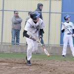 Evan Thompson / The Record &mdash; South Whidbey freshman Carson Wrightson looks up to watch his hit soar over the center field barrier for a home run on Monday afternoon against King&rsquo;s. The Falcons won 10-0.