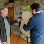 Justin Burnett/The Record &mdash; Clinton resident and ferry commuter David Freed speaks with a Washington State Ferries representative at a recent open house. The event presented plans for a schedule change to address tardy sailings on the Clinton-to-Mukilteo ferry route.