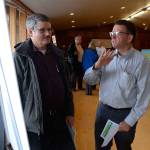 Justin Burnett/The Record &mdash; Washington State Ferries Planning Director Ray Deardorf speaks with a man during a recent open house concerning an experimental schedule change.