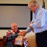 Kyle Jensen / The Record &mdash; Deer Lagoon Grange Master Chuck Prochaska presents an award to United States Navy veteran Gary Kay after Anita Smith presented him with a quilt made from her volunteer group.