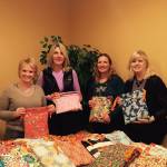 Conrtibuted photo &mdash; Days for Girls South Whidbey sews kits bound for girls all over the world. Left to right, Janette Skaardal, Michele Bolvin, Cindi Bowen and Traci Winn display some of the 100 kits taken by Freeland Trinity Lutheran Church to Haiti.