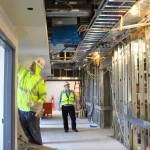 Patricia Guthrie / Whidbey News-Times &mdash; George Senerth (right) WhidbeyHealth executive director of facilities, checks on construction progress of the new addition. Its innovative heating and cooling system is predicted to reduce energy use by half.