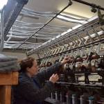 Kyle Jensen / The Record &mdash; Abundant Earth Fiber owner Lydia Christiansen operates the pin drafter, a machine that ensures the fabric is consistent. She bought the machinery from an elderly couple from Oklahoma.
