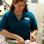 Patricia Guthrie / Whidbey News-Times &mdash; At Island Drug in Oak Harbor, pharmacy tech Lisa Bacolo sorts through the many prescription cards customers bring. in