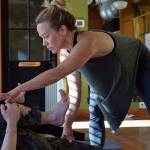 Kyle Jensen / The Record &mdash; Sojourn Studios owner Jennifer Lovely helps her students hold positions. The class holds poses longer than usual to mimic the discomfort experienced in recovery, trauma and anxiety.