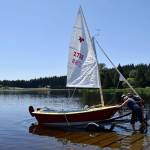 Kyle Jensen / The Record &mdash; An eager sailor is the first to push their boat onto the water on opening day.