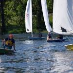 Kyle Jensen / The Record &mdash; Sailors race to the finish line, while Malbin (left) gives pointers to the younger sailors.
