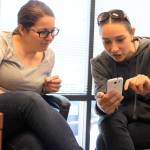 At the Compass Health Oak Harbor office, client Amanda Buchanan shows photos of her son to Ryan O&rsquo;Donnell, supervisor of a team of mental health therapists who visited Buchanan, her son and family at home for the past year.                                Photo by Patricia Guthrie/Whidbey News-Times