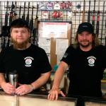 Contributed photo &mdash; New Whidbey Arms co-owners Craig Justus (left) and Mark Henny (right) saved the gun shop from closing when they purchased the business.