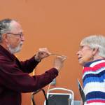 Contributed photo &mdash; Whidbey Audubon Society board member Joe Sheldon (left) shows off a feather at one of Audubon&rsquo;s &ldquo;bird in the hand&rdquo; events.