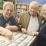 Evan Thompson / The Record &mdash; Sharon Cattron Edwards, left, and Nedra Floyd Paulter point to their 1966 senior class photos during the farewell event at Langley Middle School on Friday. Floyd Paulter&rsquo;s husband, Tom, is in the middle.