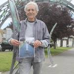 Evan Thompson / The Record &mdash; Frank Rose, chairman of the Langley Arts Commission, holds a picture of what Clyde Alley looked like before it received an artistic facelift. More art is on the way for the connecting alley between Second Street and Third Street.