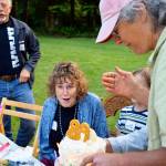 Cary Peterson (right) presents her mother, Meg Noble Peterson, with a birthday cake Saturday at a Langley neighborhoodpicnic. Peterson, who just turned 89, is representative of Whidbey Island&rsquo;s ranking as a leader in longevity. Photos by Patricia Guthrie/South Whidbey Record