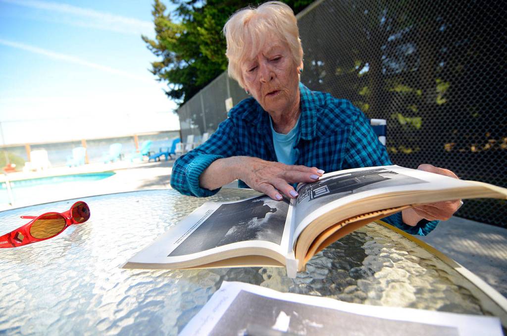 Justin Burnett/The Record &mdash; Betty Discher, the granddaughter of Minnie Spencer-Plumb, flips through a book about South Whidbey&rsquo;s history at the Honeymoon Lake Community Club&rsquo;s clubhouse.