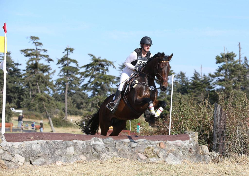 Greta Seyfried, riding I&rsquo;m Your Huckleberry, participates in cross country jumping Saturday. Seyfried attended Oak Harbor High School this past year as an exchange student. (Photo by John Fisken)