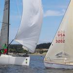 Avoiding collisions is part of the challenge during competition because as many as five dozen yachts race in a triangular pattern around buoys. These two boats safely passed one another.