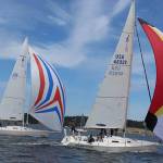 Trying to catch as much wind as possible for speed, boats furl out their spinnakers, sometimes called kites, and fly over Penn Cove waters. Photos by Patricia Guthrie/Whidbey News-Times