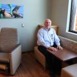 WhidbeyHealth buildings administrator George Senerth, who oversaw the 60,000-square-foot addition, shows how the couch/table set coverts to a bed. &ldquo;Family zones&rdquo; in each patient room encourage loved ones to stay close and spend the night. Photo by Patricia Guthrie/Whidbey News Group