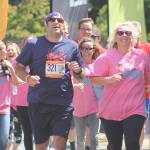 Evan Thompson / The Record &mdash; Mickey Nelson, left, runs to the finish line with his Run for Ron teammates on Saturday. The Northwest Passage Ragnar Relay began in Blaine on July 14 and ended at the Island County Fairgrounds on July 15. To Nelson&rsquo;s left is Cherie Campbell.