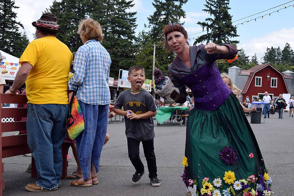 Kyle Jensen / The Record &mdash; Kids chase Hahna Luna (right) while she performs her &ldquo;Fairy Magic&rdquo; entertainment routine.