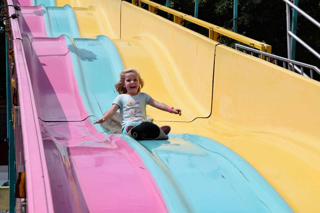 Kyle Jensen / The Record &mdash; A young girl bombs down a massive slide during opening day.