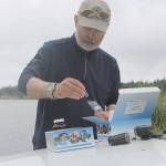 Evan Thompson / The Record &mdash; Clyde Jenkins of the South Whidbey Yacht Club collected water samples from Lone Lake on Thursday morning. The samples are being sent to King County for further analysis.
