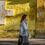 Marsha Morgan photo &mdash; Marsha Morgan&rsquo;s &ldquo;Remembrance&rdquo; depicts a women walking through the colorful streets of Cuba with flowers in her hand.