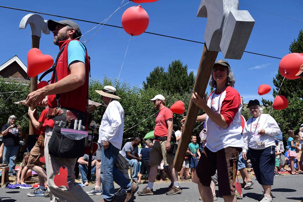Kyle Jensen / The Record &mdash; Hearts & Hammers, the volunteer organization that does repair work on roughly 30 houses per summer, joined in on the parade festivities.