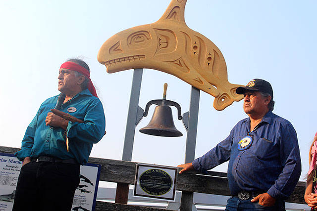 Lummi Nation members Jewell James (left) and Douglas James, Jr. in front of the Coupeville whale bell speaking on the cultural significance of returning Lolita to her ancestral home. Photo by Patricia Guthrie/Whidbey News-Times