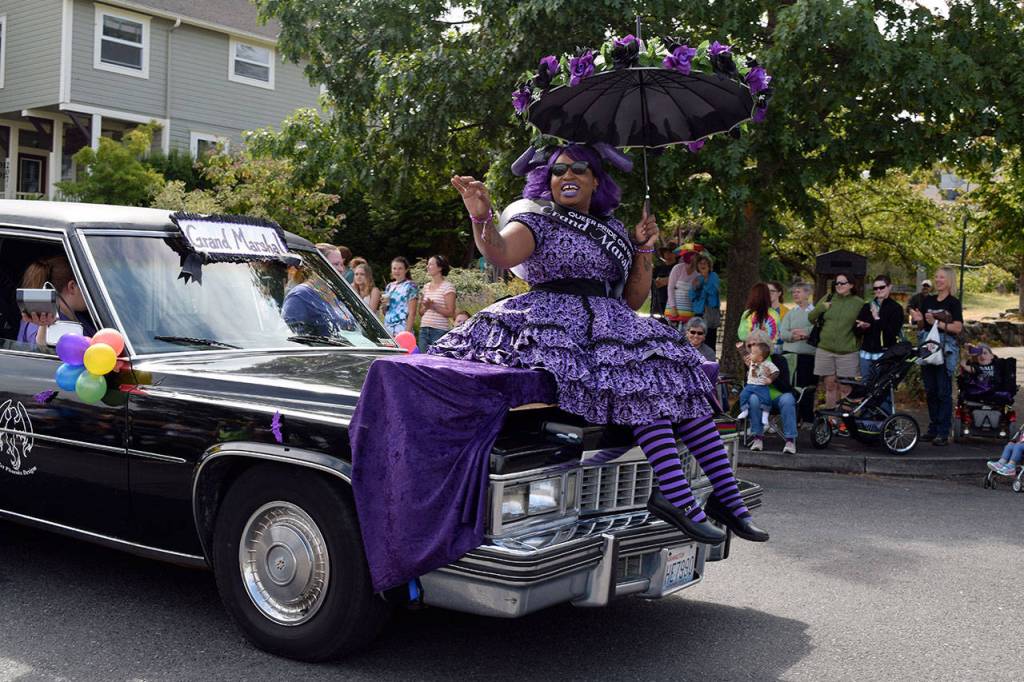 Kyle Jensen / The Record &mdash; Parade Grand Marshal Pandora Violet Phoenix leads the way from the hood of her hearse. Phoenix owns a successful seamstress business in Oak Harbor.