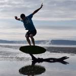 Kyle Jensen / The Record &mdash; Reisman jumps over a piece of driftwood Friday morning.
